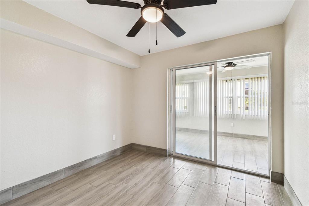 4726 Marine Parkway, Unit 103 New Port Richey, FL 34652 - Photo 29 of 81 a view of empty room with wooden floor and ceiling fan