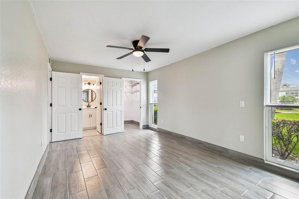 4726 Marine Parkway, Unit 103 New Port Richey, FL 34652 - Photo 33 of 81 a view of empty room with wooden floor and fan