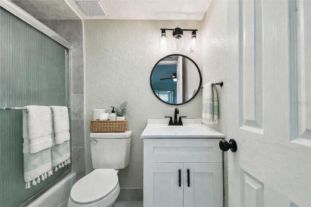 4726 Marine Parkway, Unit 103 New Port Richey, FL 34652 - Photo 37 of 81 a bathroom with a toilet sink and mirror