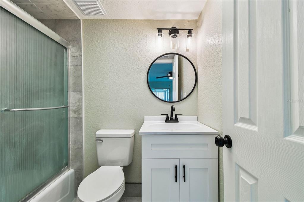 4726 Marine Parkway, Unit 103 New Port Richey, FL 34652 - Photo 39 of 81 a bathroom with a toilet sink and mirror
