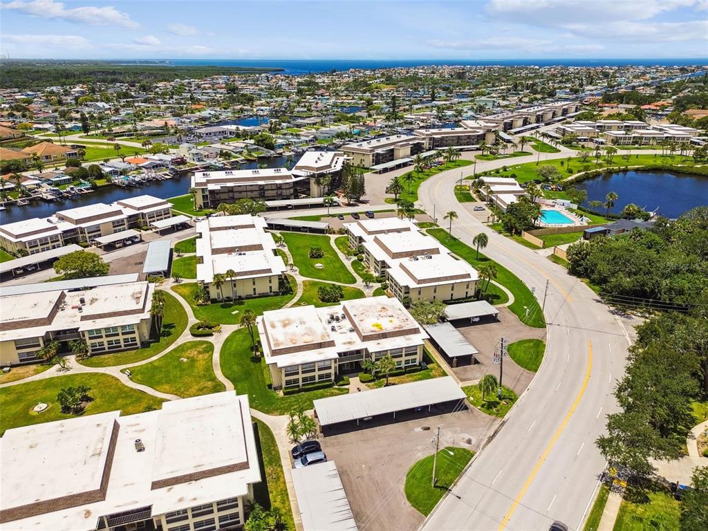4726 Marine Parkway, Unit 103 New Port Richey, FL 34652 - Photo 50 of 81 an aerial view of residential houses with outdoor space and swimming pool