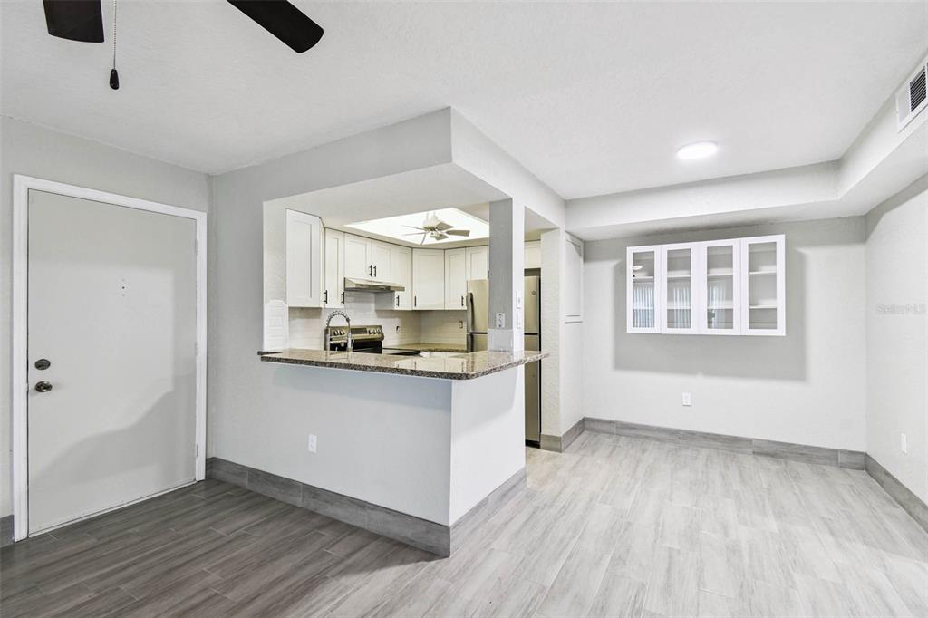 4726 Marine Parkway, Unit 103 New Port Richey, FL 34652 - Photo 6 of 81 a kitchen with a wooden floor and window