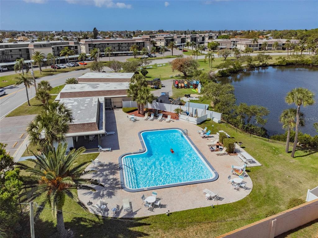 4726 Marine Parkway, Unit 103 New Port Richey, FL 34652 - Photo 61 of 81 an aerial view of a house with a garden and lake view