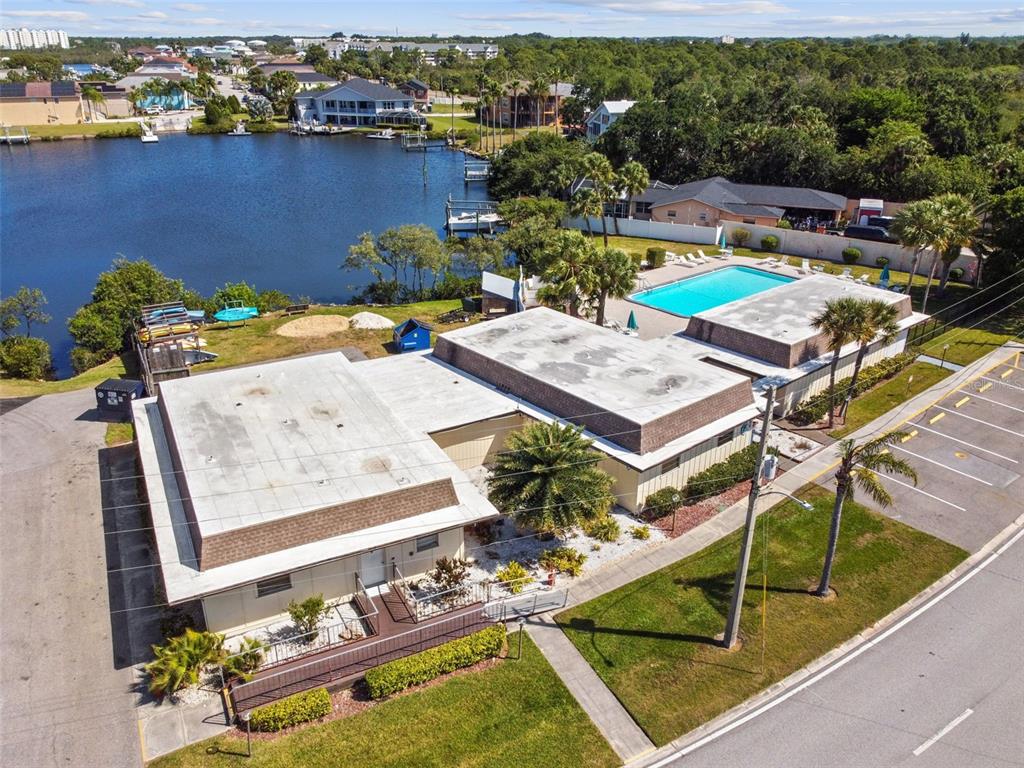 4726 Marine Parkway, Unit 103 New Port Richey, FL 34652 - Photo 66 of 81 a view of a swimming pool with lounge chairs