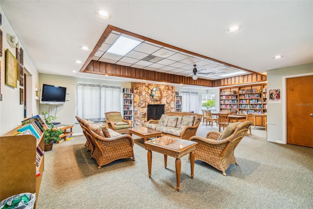 4726 Marine Parkway, Unit 103 New Port Richey, FL 34652 - Photo 77 of 81 a living room with patio furniture and a flat screen tv