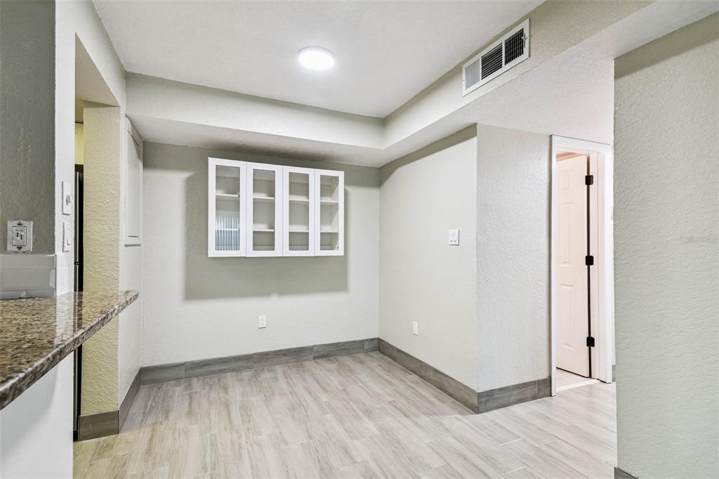 4726 Marine Parkway, Unit 103 New Port Richey, FL 34652 - Photo 10 of 81 an empty room with wooden floor and windows