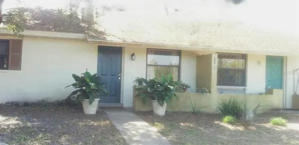 a view of a house with potted plants