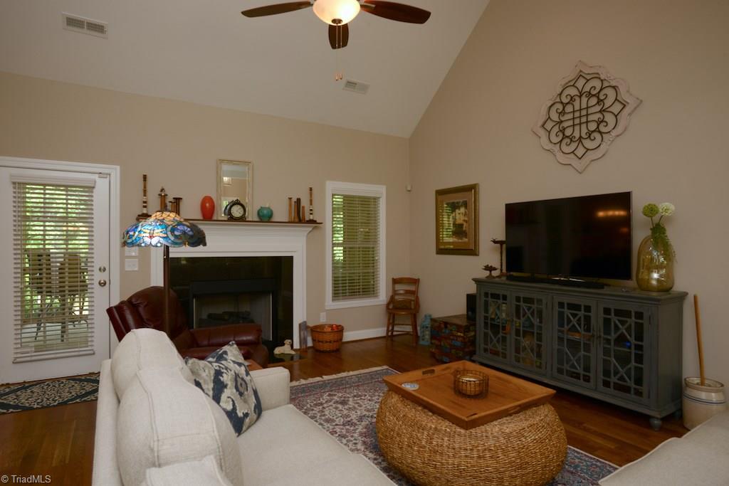 5002 Bennington Way High Point, NC 27262 - Photo 2 of 30 Spacious family room with expanded mantle opens onto screened porch