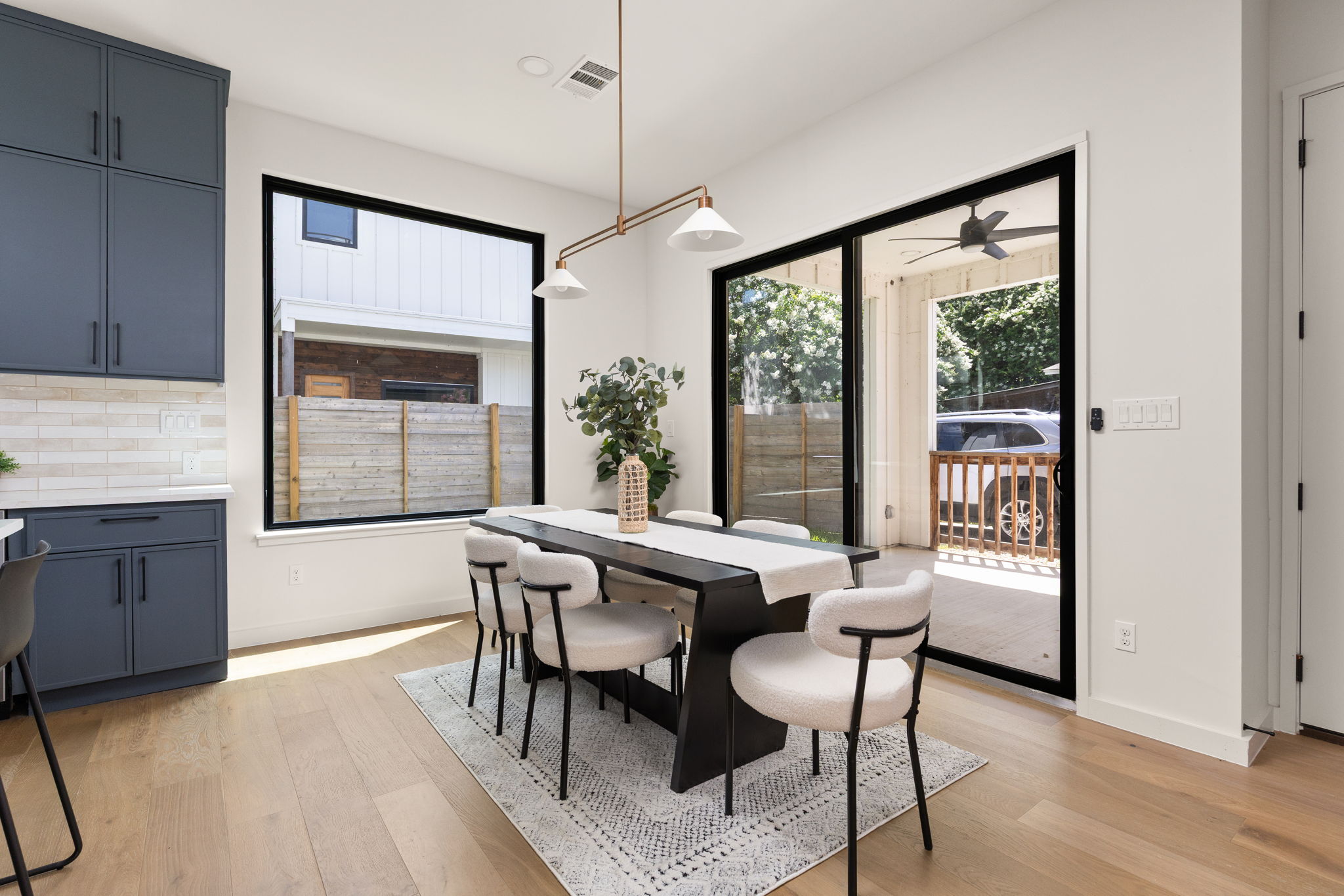 2717 Lyons Road, Unit 1 Austin, TX 78702 - Photo 15 of 40 A refined dining space connects to an outdoor area through expansive glass sliding doors.