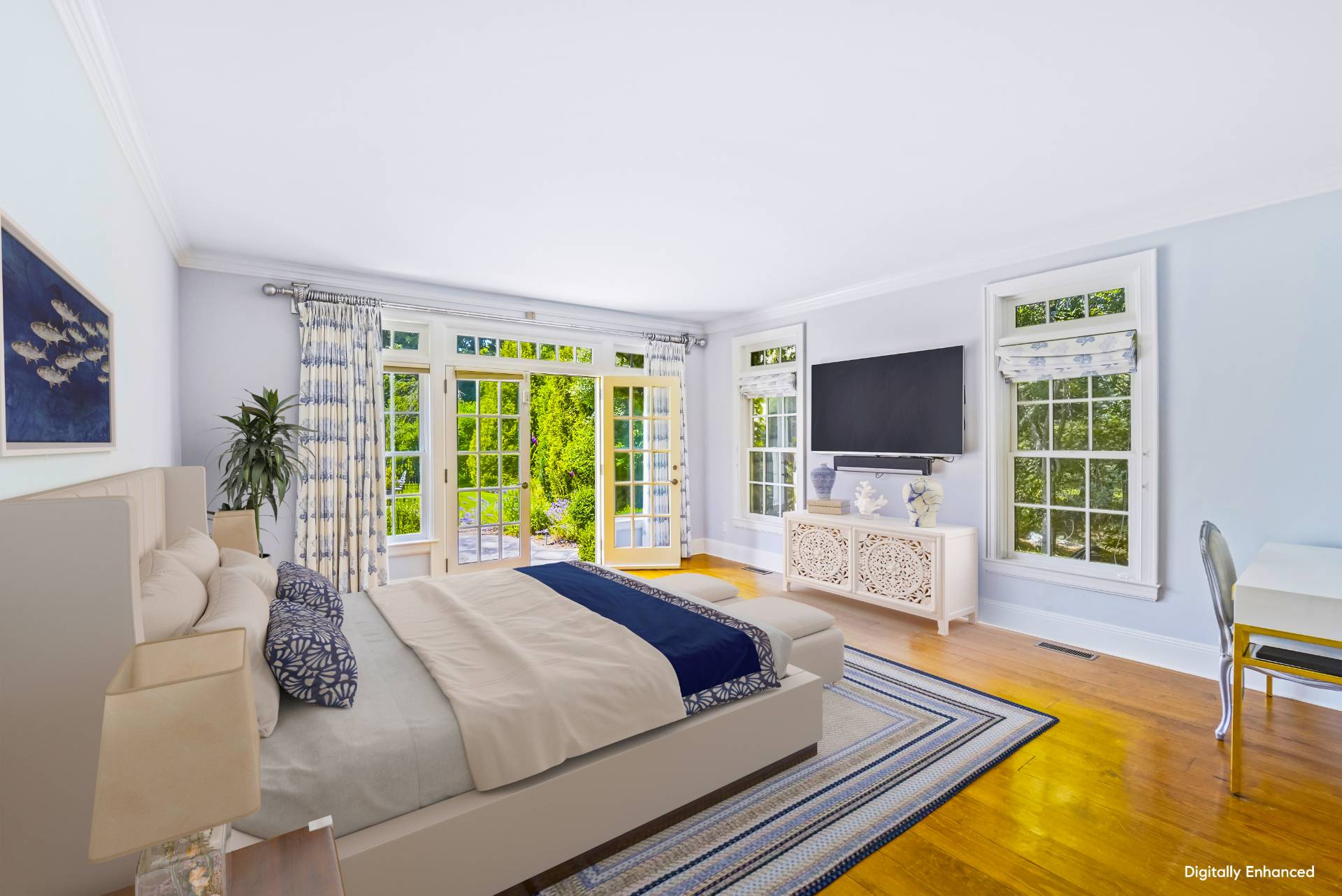 53 South Road Westhampton Beach, NY 11978 - Photo 12 of 28 a bedroom with a bed and a flat screen tv