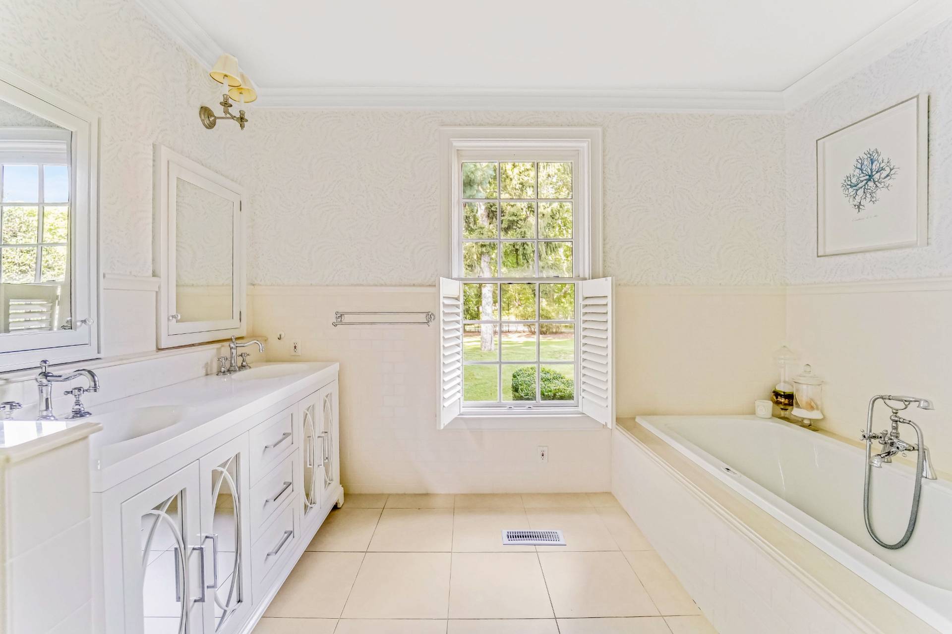 53 South Road Westhampton Beach, NY 11978 - Photo 13 of 28 a spacious bathroom with a tub sink and mirror