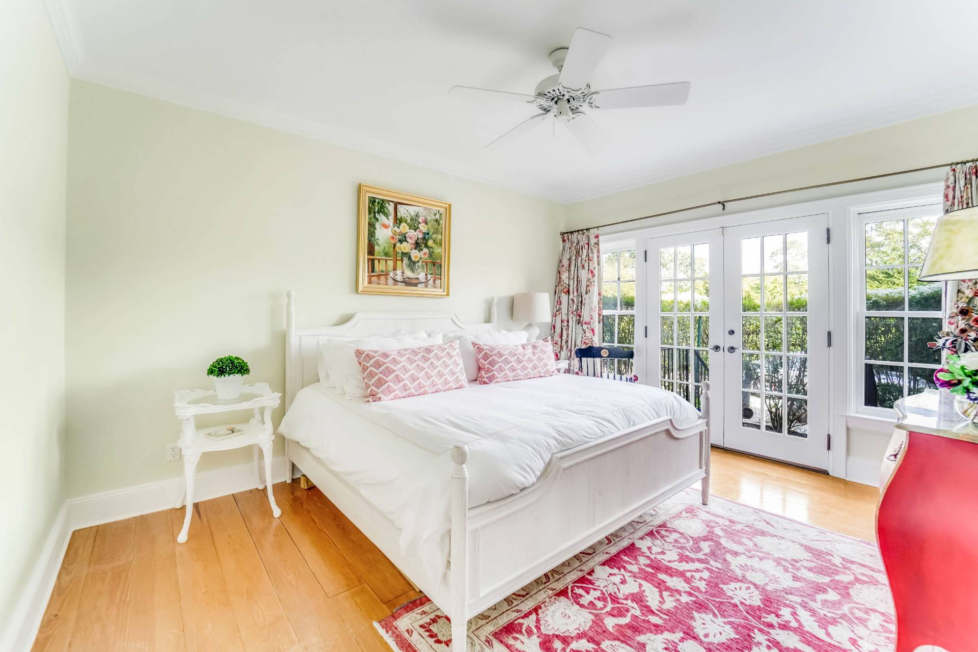 53 South Road Westhampton Beach, NY 11978 - Photo 15 of 28 a bedroom with a large bed and a chandelier