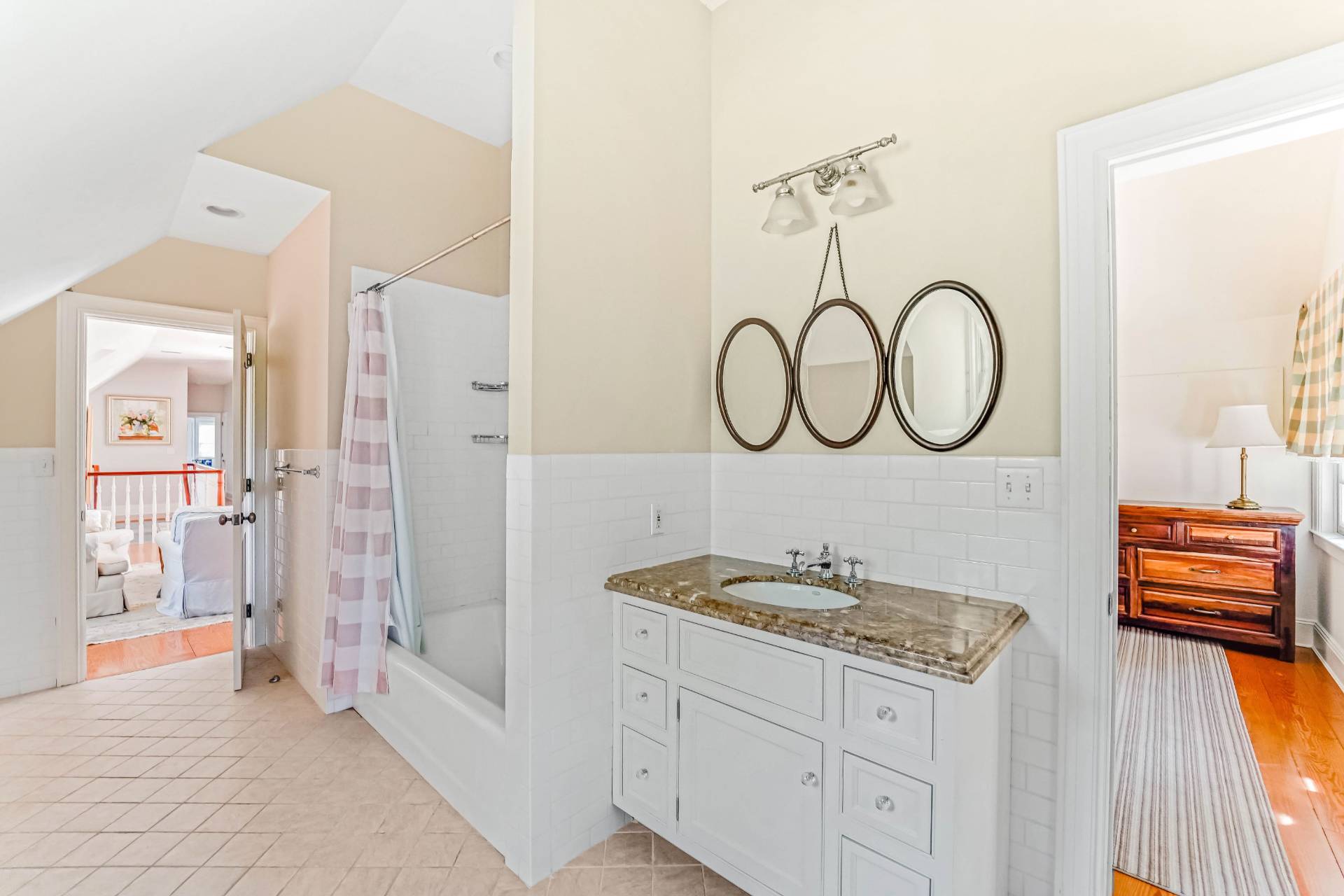 53 South Road Westhampton Beach, NY 11978 - Photo 19 of 28 a spacious bathroom with a granite countertop sink and a mirror