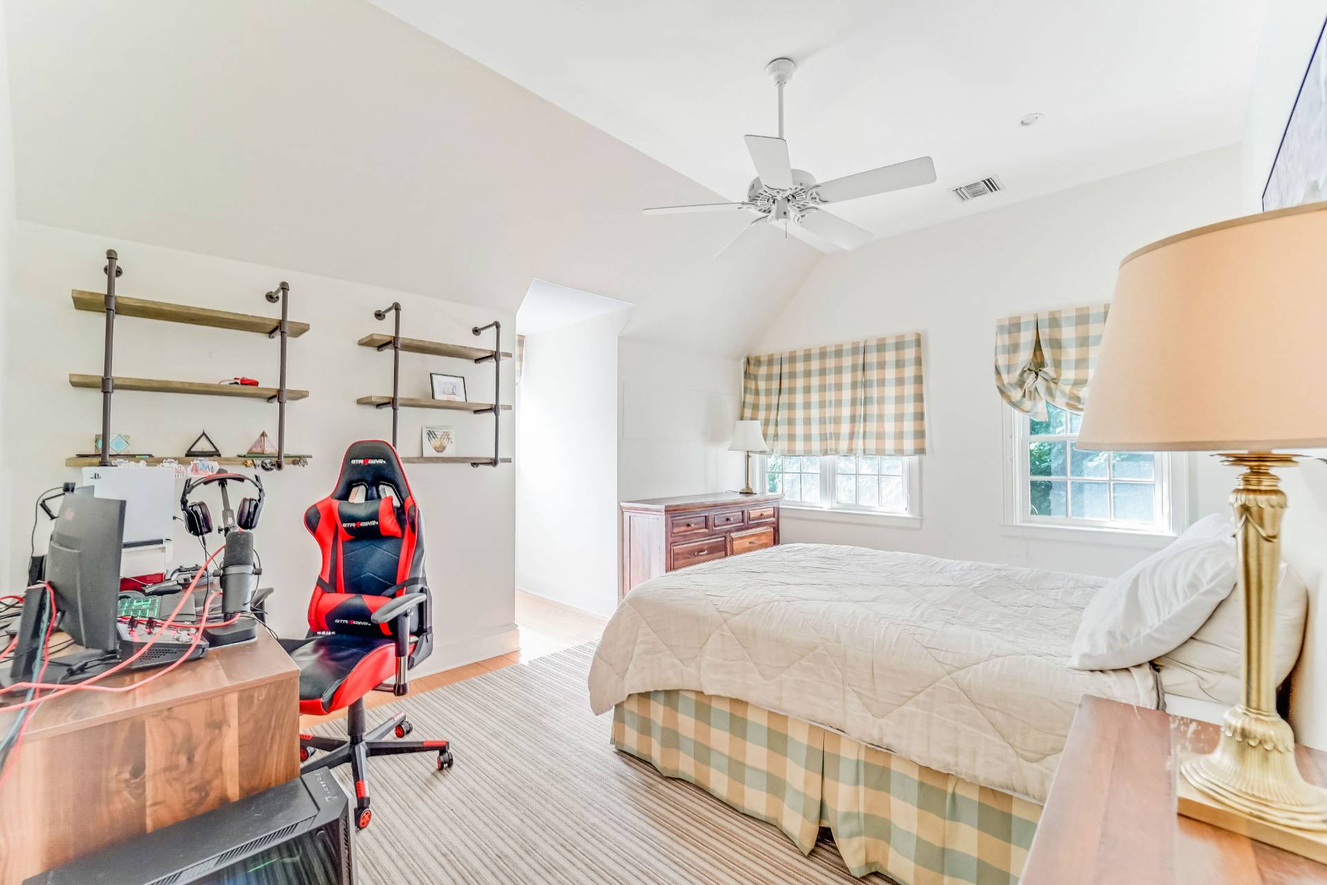 53 South Road Westhampton Beach, NY 11978 - Photo 20 of 28 a bedroom with a bed and a chandelier