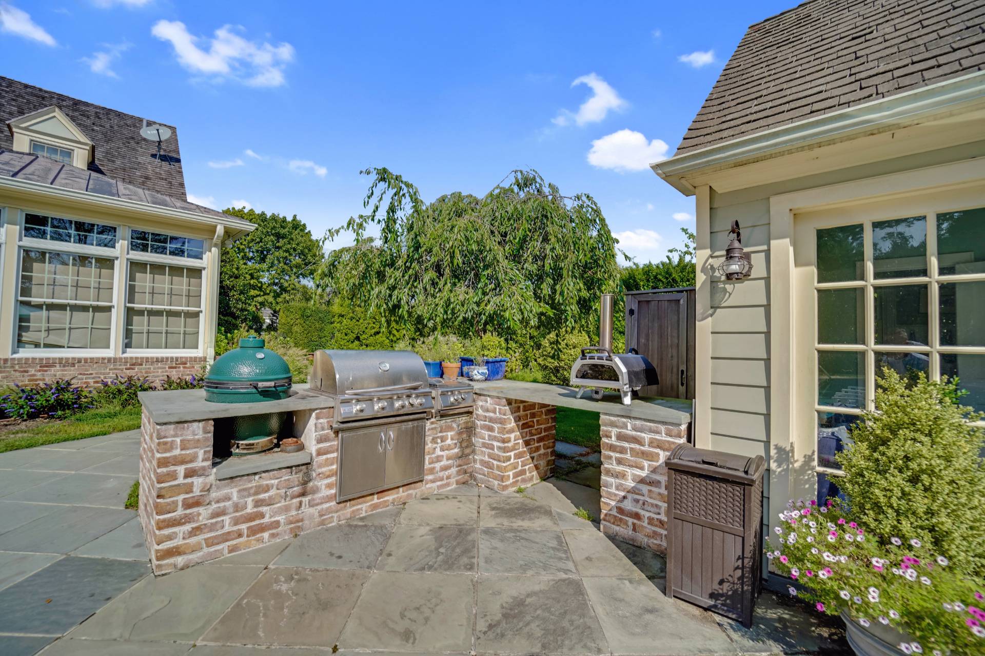 53 South Road Westhampton Beach, NY 11978 - Photo 25 of 28 a view of a patio with a table and chairs and potted plants