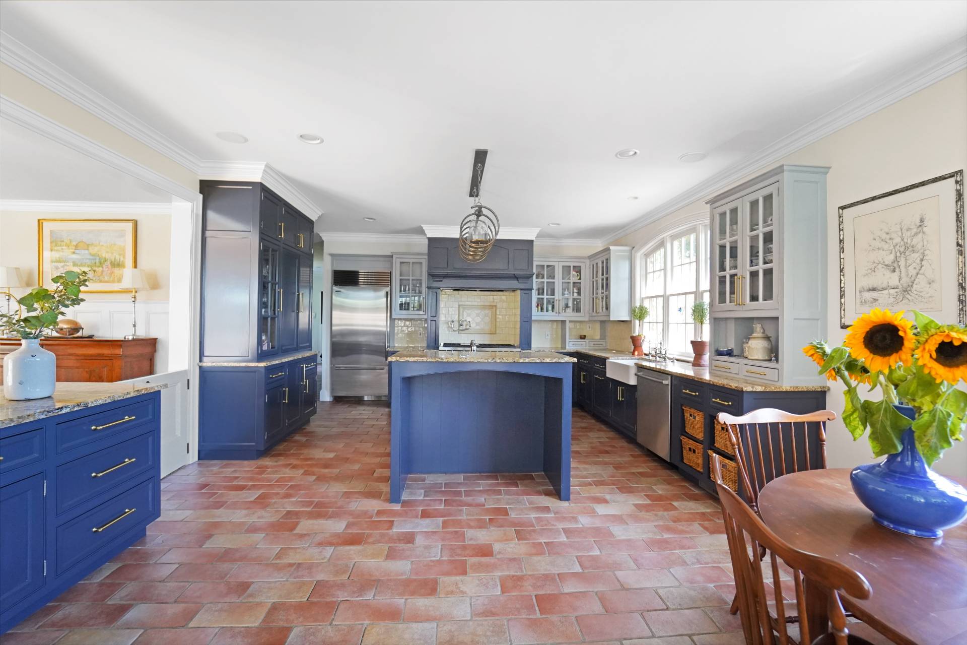 53 South Road Westhampton Beach, NY 11978 - Photo 9 of 28 a kitchen with stainless steel appliances granite countertop a stove a sink dishwasher and a dining table with garden view