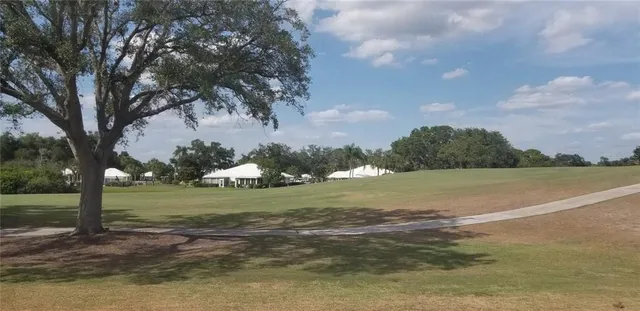 a view of a field with an trees