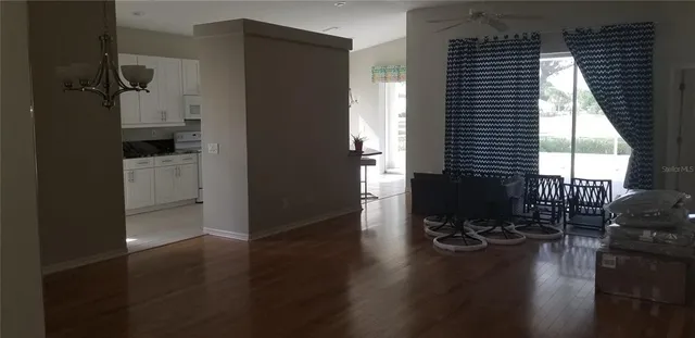 an empty room with wooden floor and a window