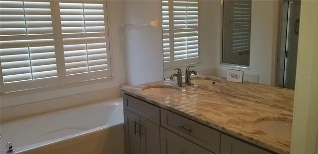 a view of a house with a floor to ceiling window and a tree