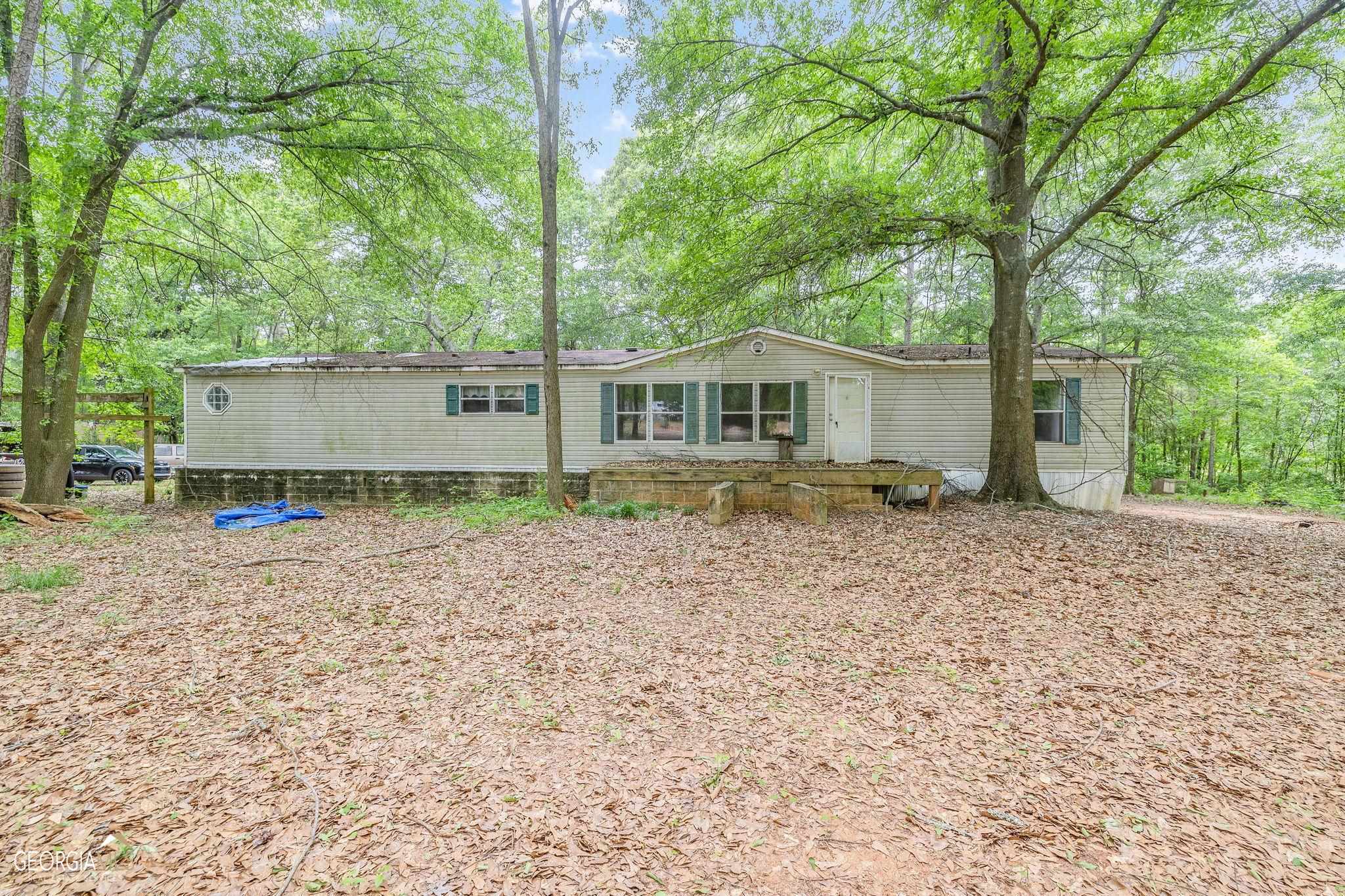 157 Reynolds Road Athens, GA 30607 - Photo 1 of 1 a view of a house with a backyard and a tree