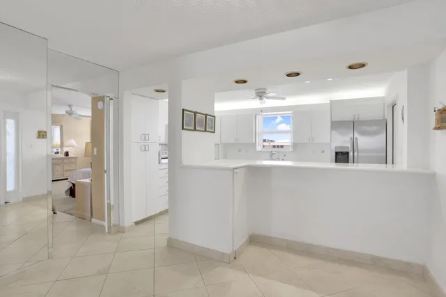 a kitchen with cabinets appliances a sink and a window