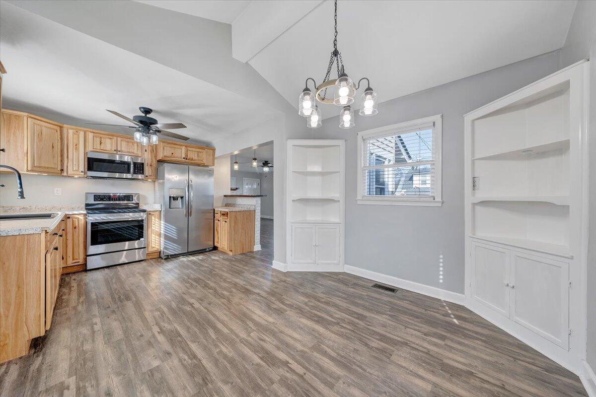 1902 Springfield Avenue Salem, VA 24153 - Photo 14 of 43 a view of a kitchen with a refrigerator a stove top oven cabinets and wooden floor