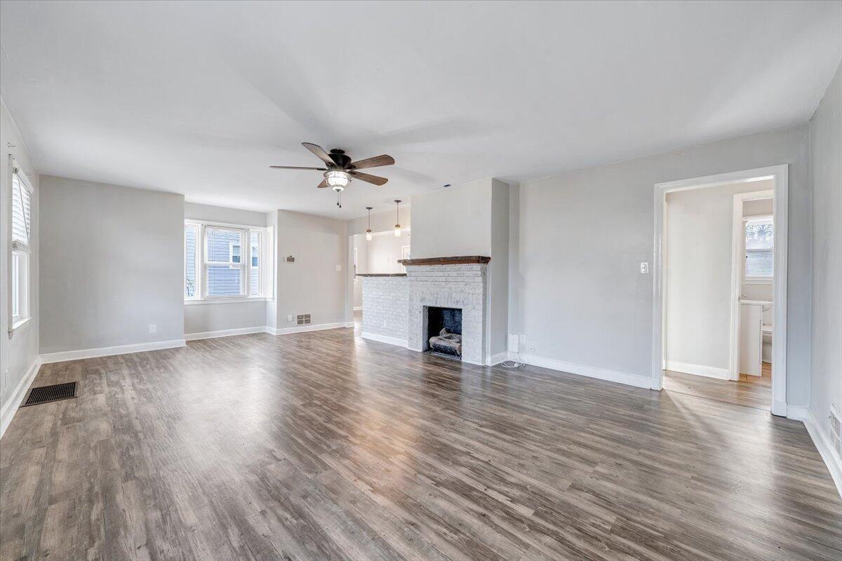 1902 Springfield Avenue Salem, VA 24153 - Photo 7 of 43 an empty room with wooden floor fireplace and windows