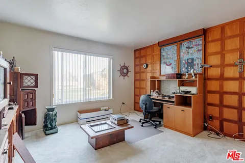 a livingroom with workspace and a window