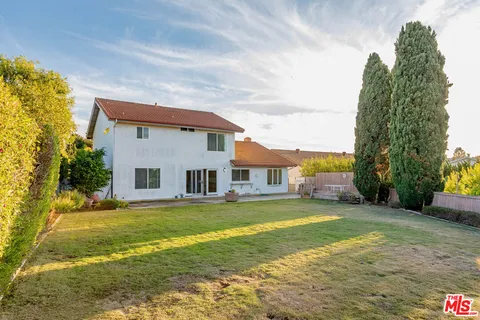 a view of a yard with a house in the background