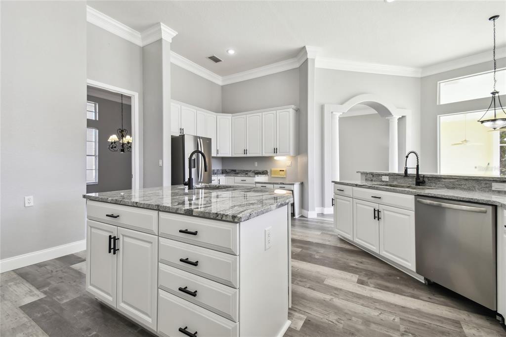 6644 Country Club Road Wesley Chapel, FL 33544 - Photo 19 of 75 a kitchen with granite countertop a sink and cabinets