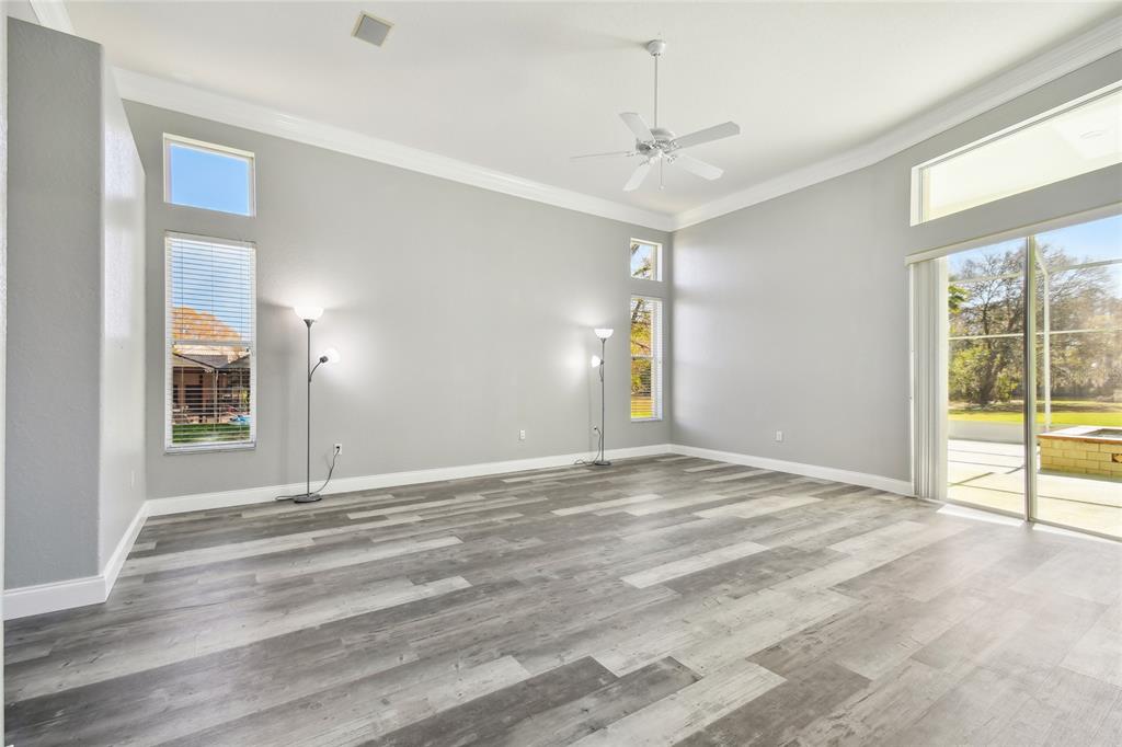 6644 Country Club Road Wesley Chapel, FL 33544 - Photo 25 of 75 a view of an empty room with window and wooden floor