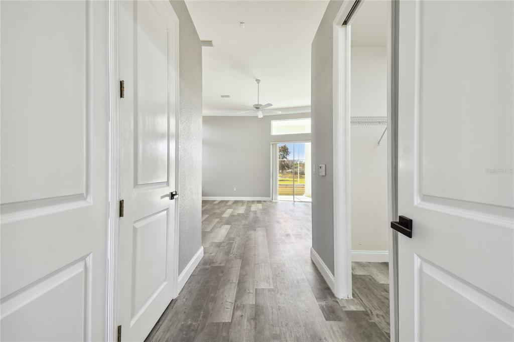 6644 Country Club Road Wesley Chapel, FL 33544 - Photo 32 of 75 a view of a hallway with wooden floor and closet area