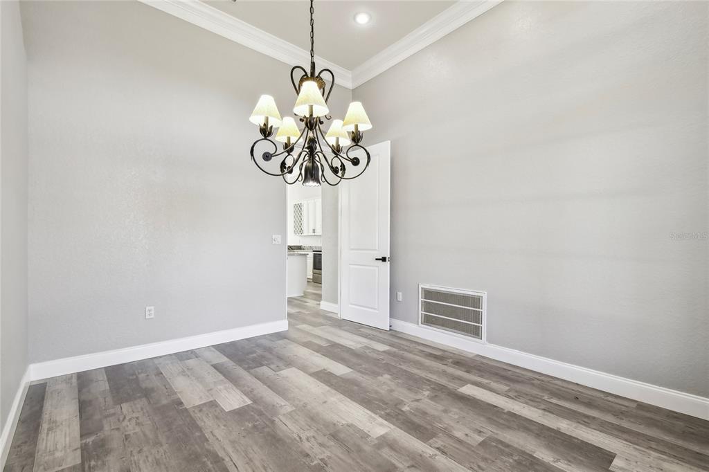 6644 Country Club Road Wesley Chapel, FL 33544 - Photo 42 of 75 a view of a chandelier fan and a refrigerator