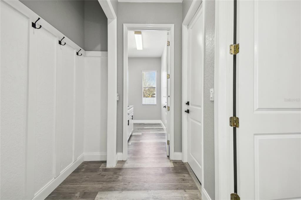 6644 Country Club Road Wesley Chapel, FL 33544 - Photo 43 of 75 a view of a hallway with wooden floor and closet area