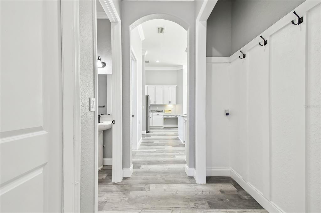 6644 Country Club Road Wesley Chapel, FL 33544 - Photo 46 of 75 a view of a hallway with wooden floor and a bathroom