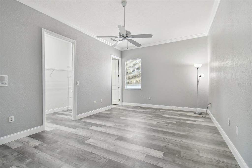 6644 Country Club Road Wesley Chapel, FL 33544 - Photo 49 of 75 a view of an empty room with window chandelier fan