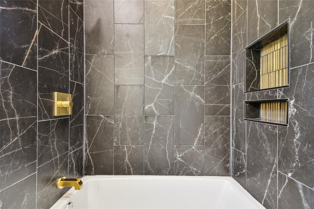 6644 Country Club Road Wesley Chapel, FL 33544 - Photo 59 of 75 a bathroom with a bathtub and shower