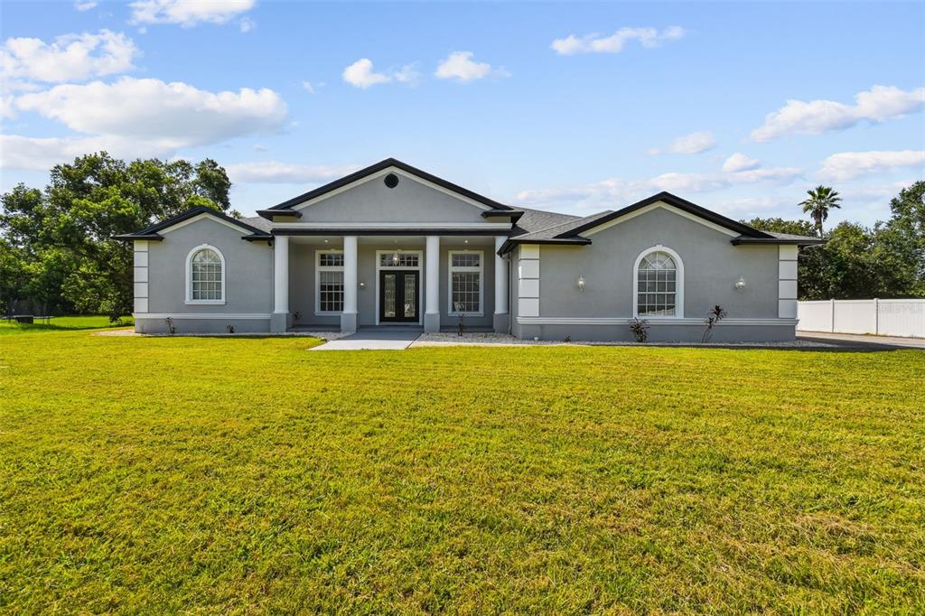 6644 Country Club Road Wesley Chapel, FL 33544 - Photo 73 of 75 a front view of a house with swimming pool and porch