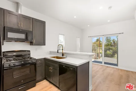 a kitchen with a sink stove and microwave