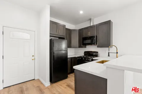 a kitchen with a refrigerator sink and microwave