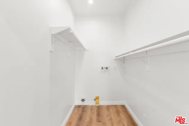 a view of a room with wooden floor