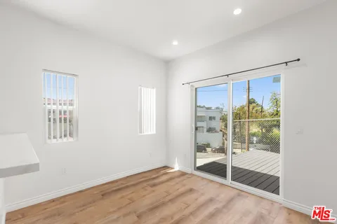 a view of an empty room with glass door