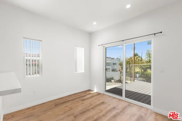 a view of an empty room with glass door