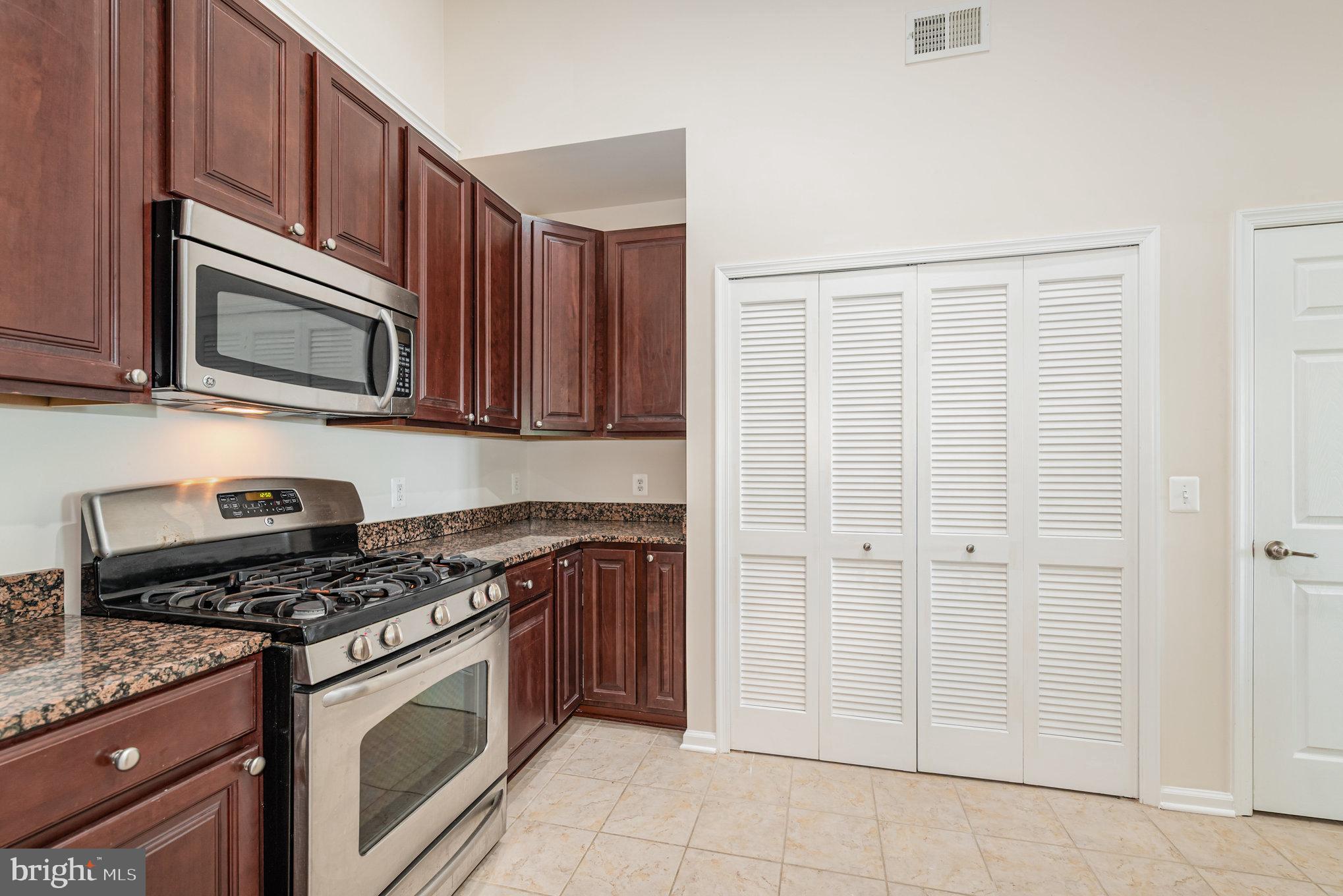 1624 Hardwick Court, Unit 402 Hanover, MD 21076 - Photo 9 of 27 a kitchen with granite countertop cabinets stainless steel appliances and a sink