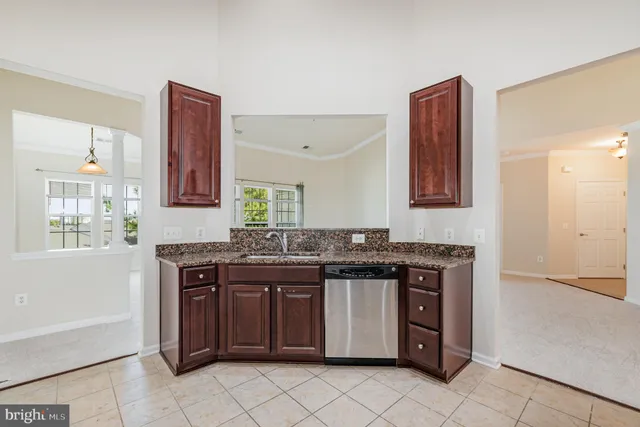a kitchen that has a sink and a stove in it
