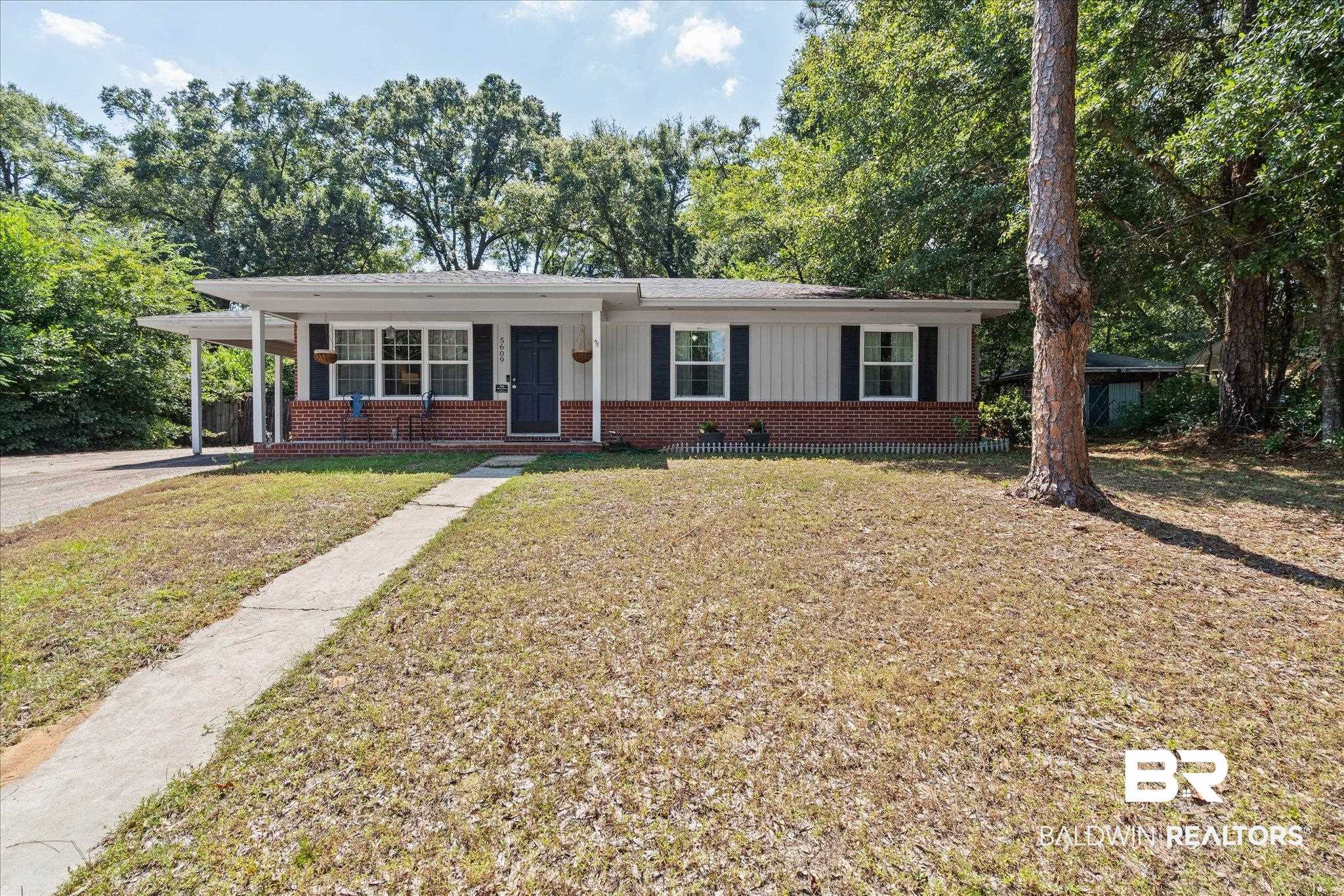5609 Diane Court Mobile, AL 36618 - Photo 21 of 22 Ranch-style home with brick siding, a front yard, covered porch, a carport, and driveway