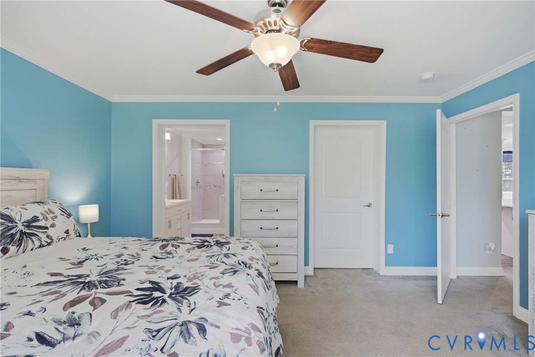 93 Faraway Road Saluda, VA 23149 - Photo 18 of 58 a bedroom with a bed and a chandelier