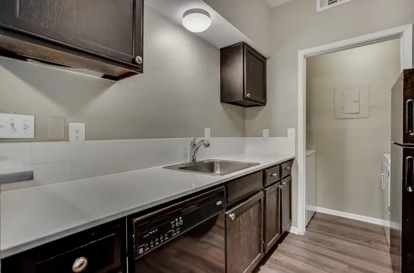 a kitchen with a sink and a refrigerator