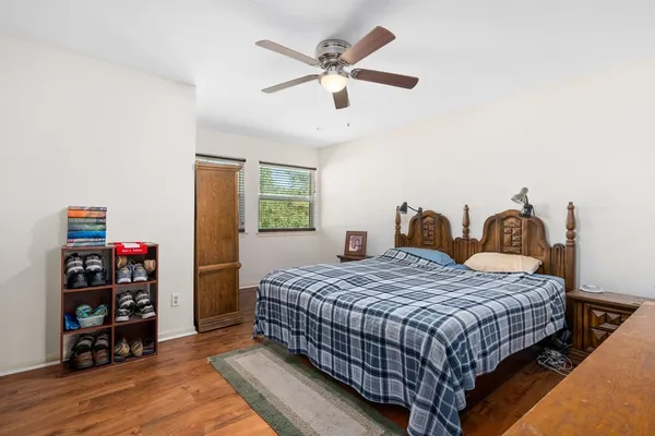 a bedroom with a bed and wooden floor