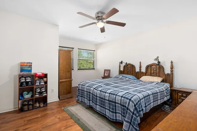 a bedroom with a bed and wooden floor